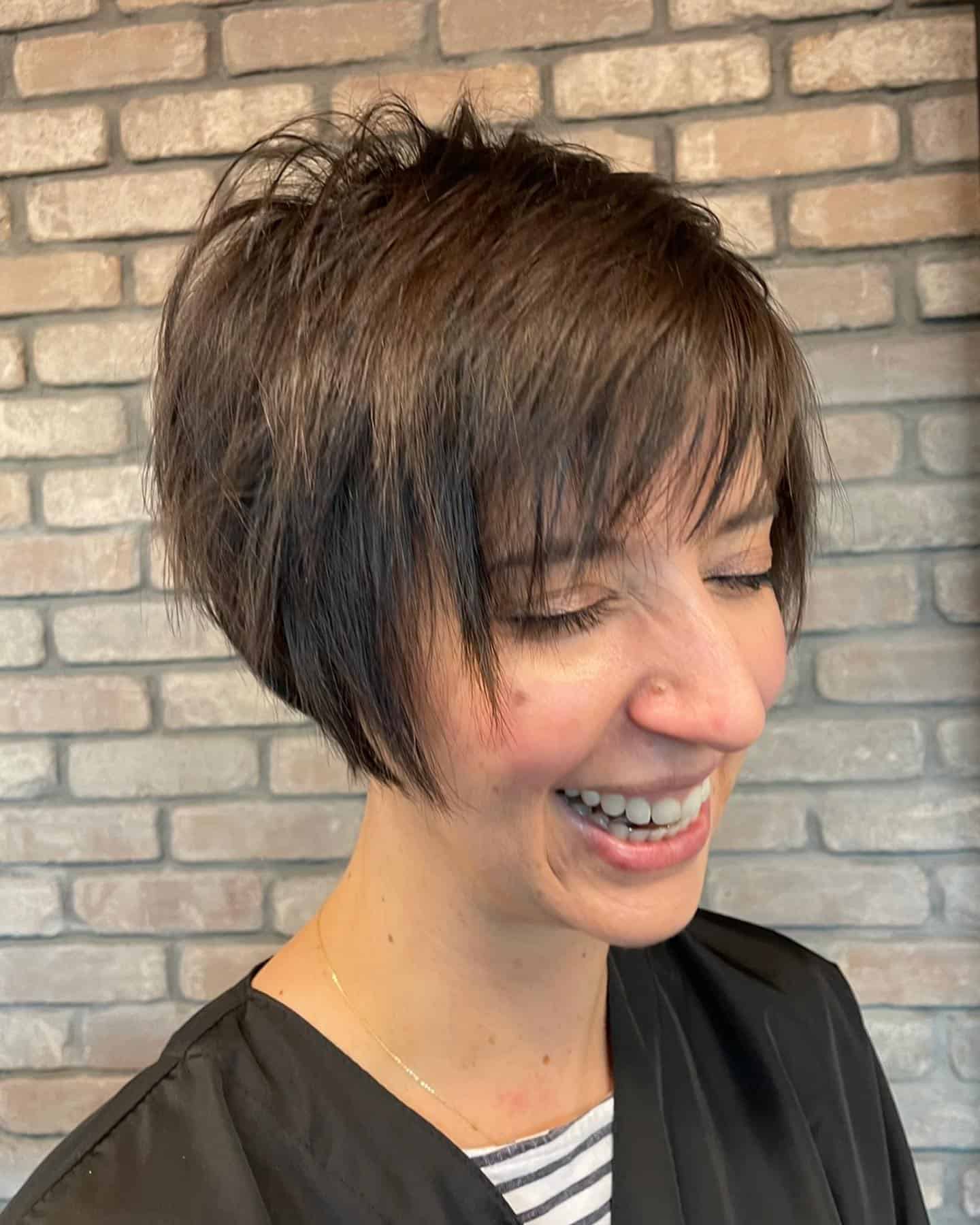 273825087_104267698853797_4287913349569006769_n Long brown bixie with wispy bangs