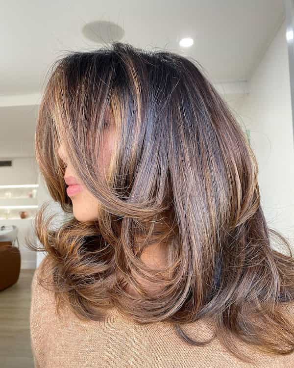 bouncy-blow-dry-feathered-haircut-with-layers-and-bangs Bouncy Blow Dry Feathered Haircut with Layers and Bangs