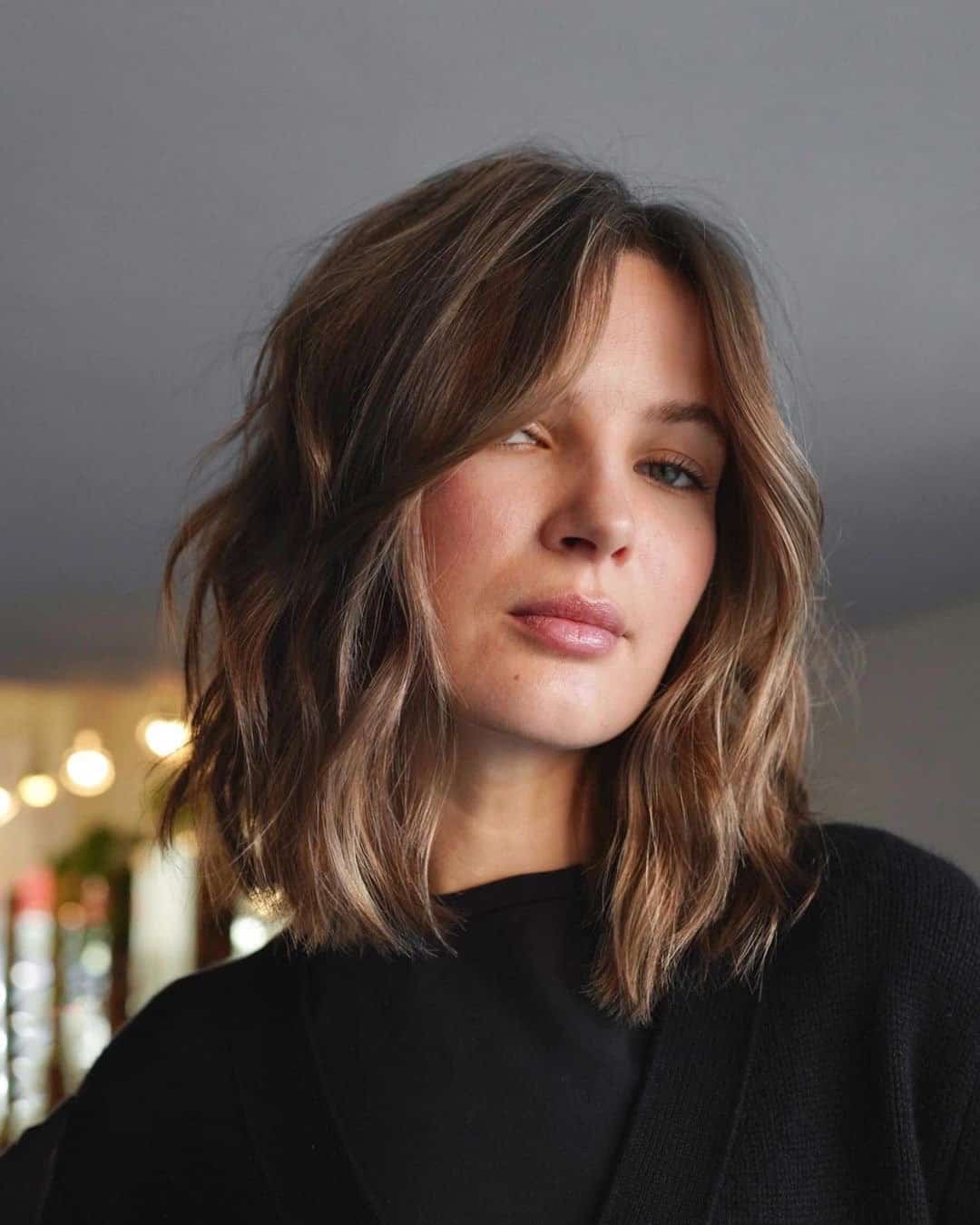 Woman with a shoulder-length lob haircut.