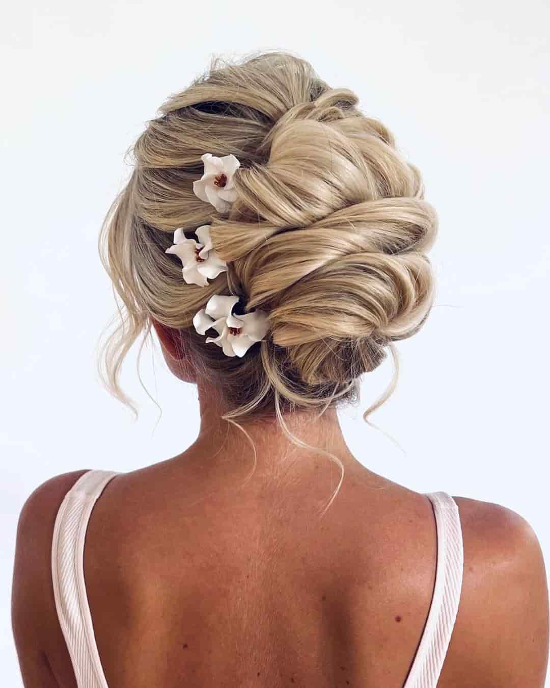 messy-interwoven-updo-with-flower-pins Messy Interwoven Updo with Flower Pins