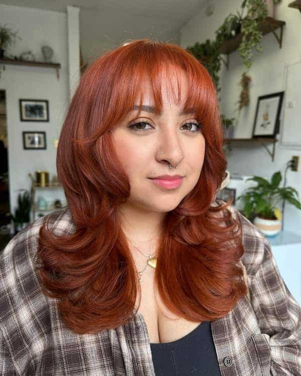 reddish-feathered-haircut-with-fringe-for-round-face Reddish Feathered Haircut with Fringe for Round Face