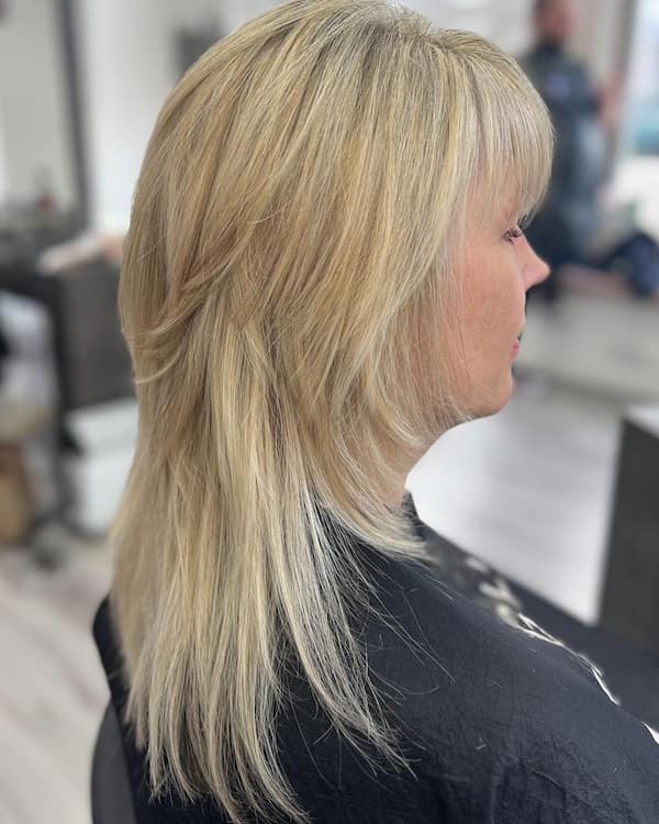 Simple Blonde Layered Haircut with Bangs for Older Women