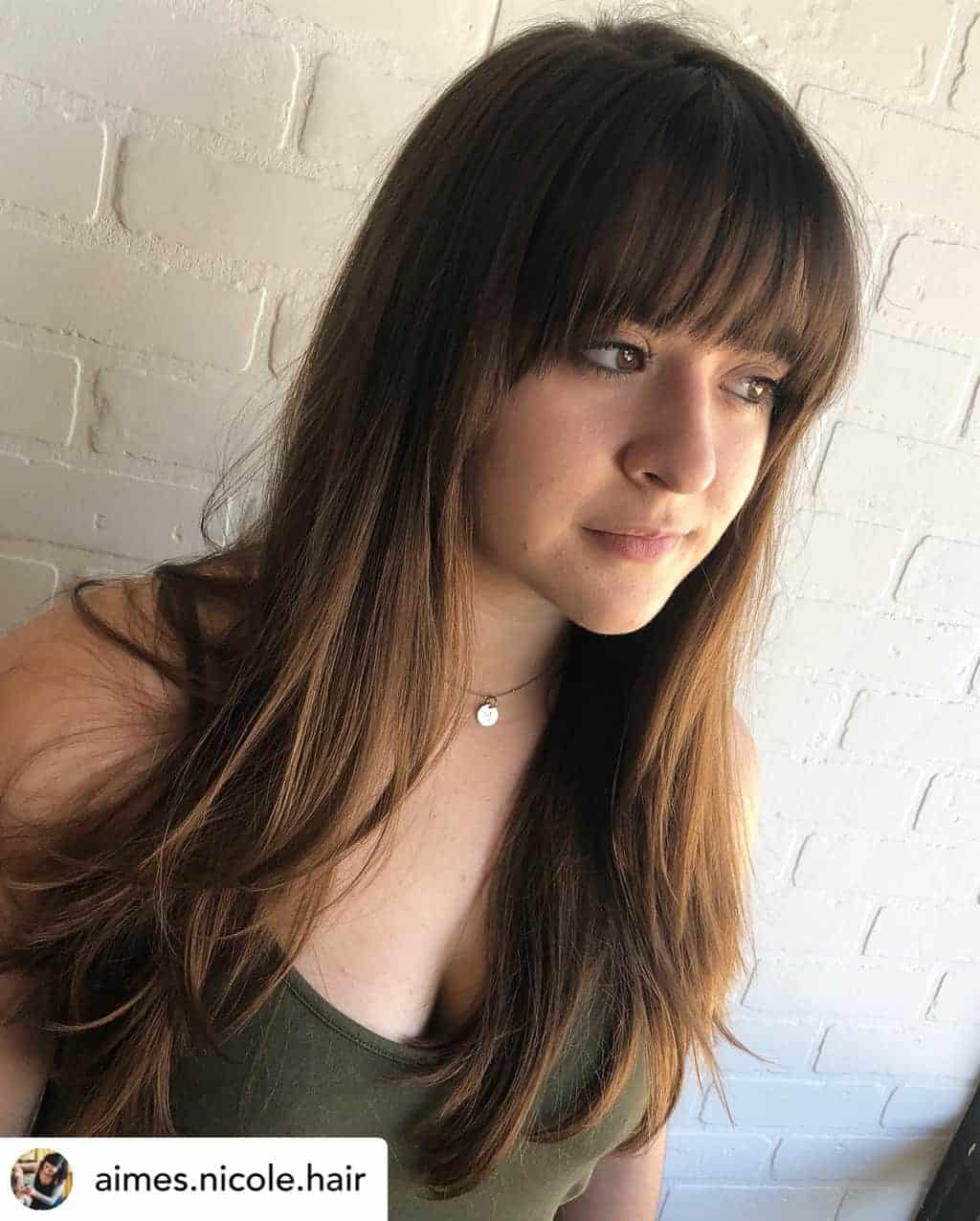 Curved bangs on beautiful brunette hair.