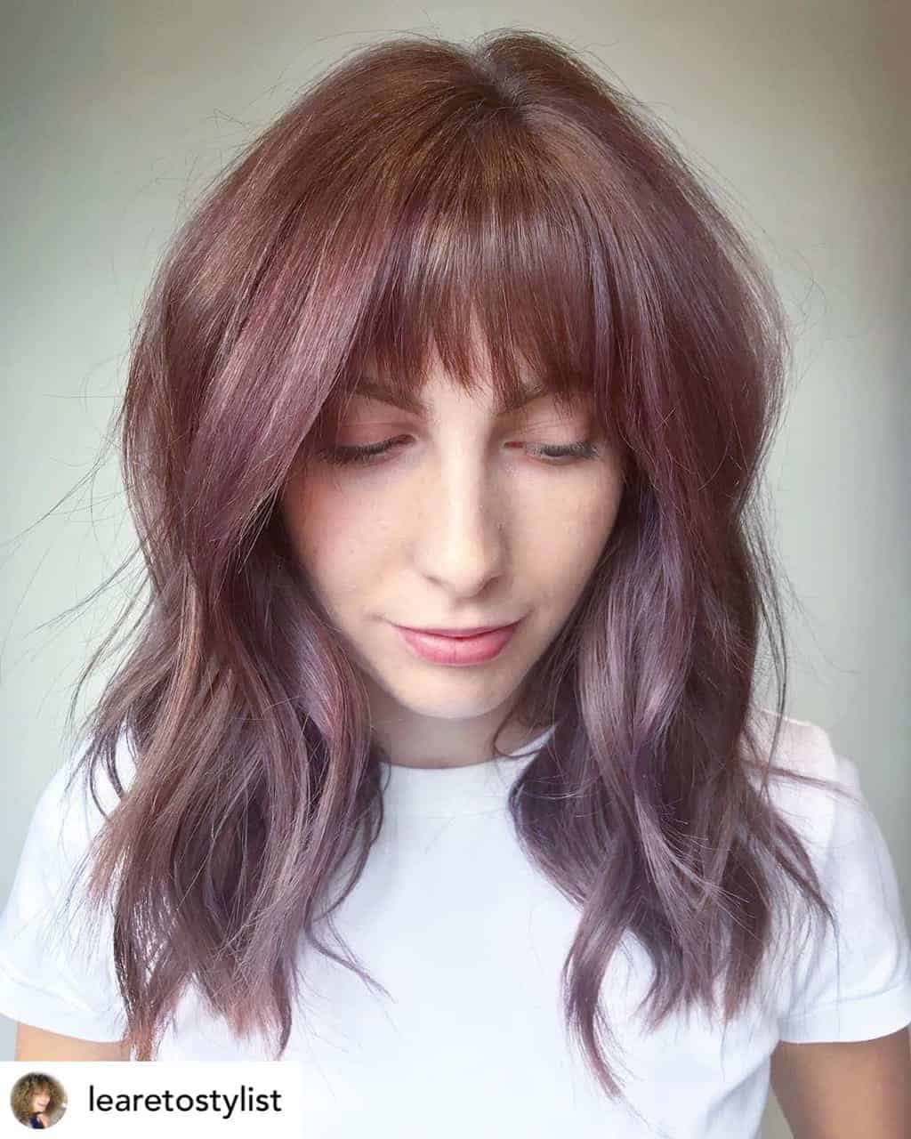 Textured bangs on beautiful brown and purple hair.
